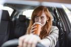Happy,Young,Woman,With,Coffee,To,Go,Driving,Her,Car.