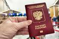 A,Hand,Holds,A,Russian,Passport,In,Line,At,Customs,