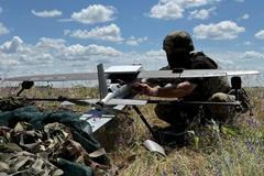 FILE PHOTO: Ukrainian serviceman prepares to launch a Hornet middle strike drone towards Russian troops from a position near a front line in Donetsk region