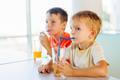 Cute,Children,Drinking,Soda,Or,Soft,Drink,With,Straw,In