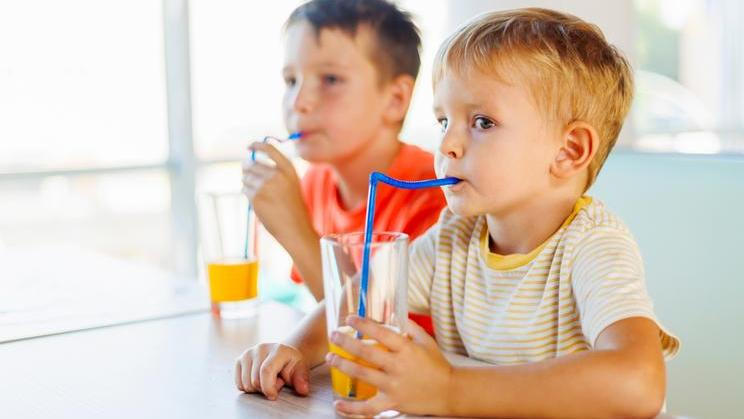 Cute,Children,Drinking,Soda,Or,Soft,Drink,With,Straw,In
