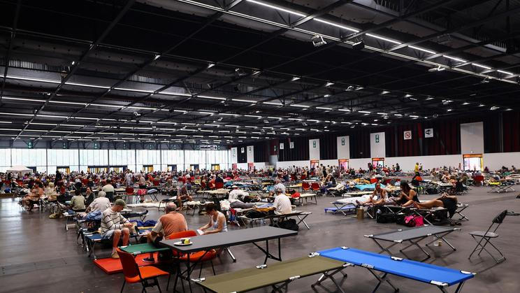 Evacuated residents rest at the Bordeaux-Lac Exhibition Centre, in Bordeaux