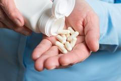 Woman,Hand,Holds,White,Medication,Capsules,Of,Glucosamine,,Pours,From