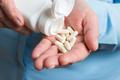 Woman,Hand,Holds,White,Medication,Capsules,Of,Glucosamine,,Pours,From