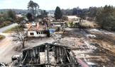 A drone view shows burnt building in an area affected by wildfire, in Le Porge
