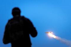 Ukrainian serviceman looks at an FP-1 deep-strike drone as it launches for a combat mission in an undisclosed location in Ukraine