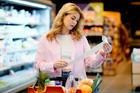 Woman,Holding,A,Long,Shopping,Receipt,In,A,Supermarket,,Checking