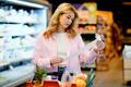 Woman,Holding,A,Long,Shopping,Receipt,In,A,Supermarket,,Checking