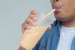 Close,Up,Man,Sucking,Bubble,Tea,Or,Thai,Tea,Or