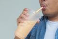 Close,Up,Man,Sucking,Bubble,Tea,Or,Thai,Tea,Or