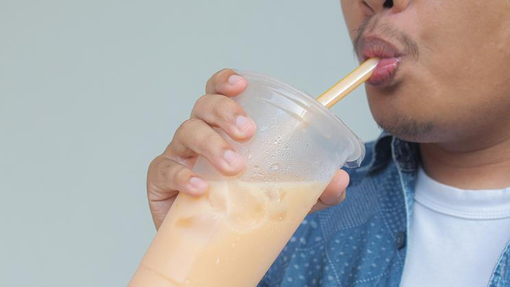 Close,Up,Man,Sucking,Bubble,Tea,Or,Thai,Tea,Or