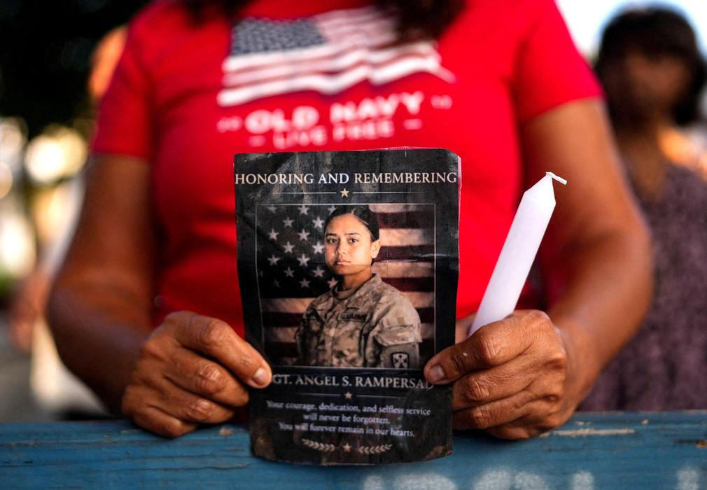 People attend a vigil for fallen U.S. soldier Sgt. Rampersad in the Queens Borough of New York City
