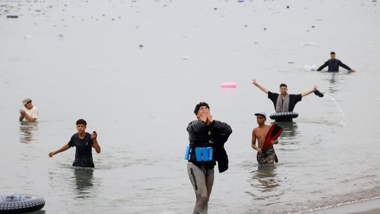 Migrants cross into the Spanish enclave of Ceuta