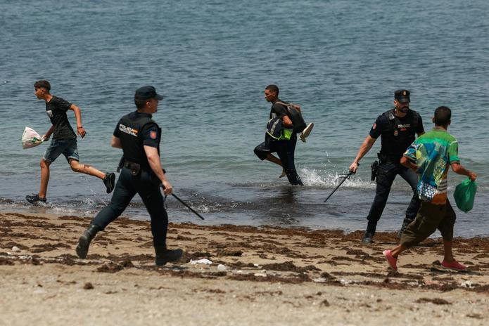 Mass crossings of migrants on foot and by sea from Morocco into Spanish territory, in Ceuta