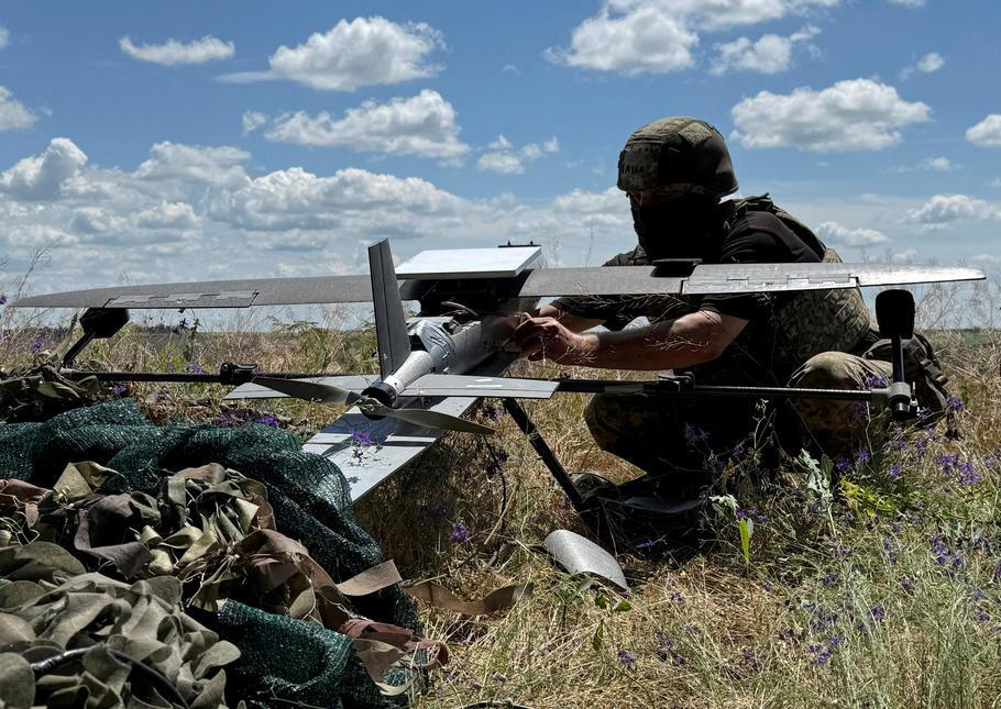 FILE PHOTO: Ukrainian serviceman prepares to launch a Hornet middle strike drone towards Russian troops from a position near a front line in Donetsk region