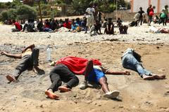 Mass crossings of migrants on foot and by sea from Morocco into Spanish territory, in Ceuta