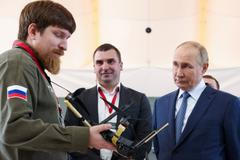 FILE PHOTO: Vladimir Tkachuk, co-founder of the Uraldronzavod, demonstrates a drone to Russian President Vladimir Putin in Saint Petersburg