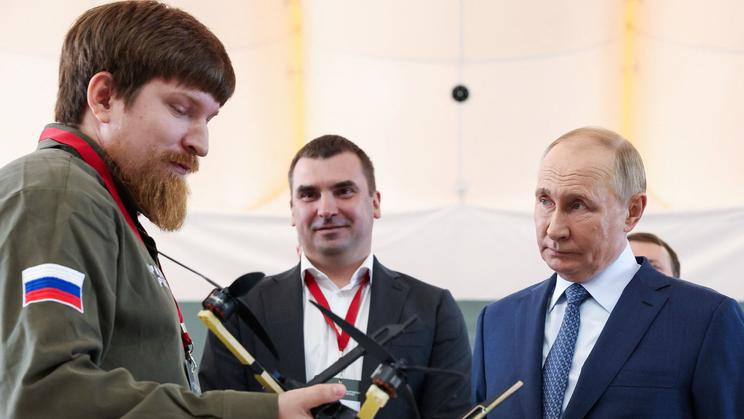 FILE PHOTO: Vladimir Tkachuk, co-founder of the Uraldronzavod, demonstrates a drone to Russian President Vladimir Putin in Saint Petersburg