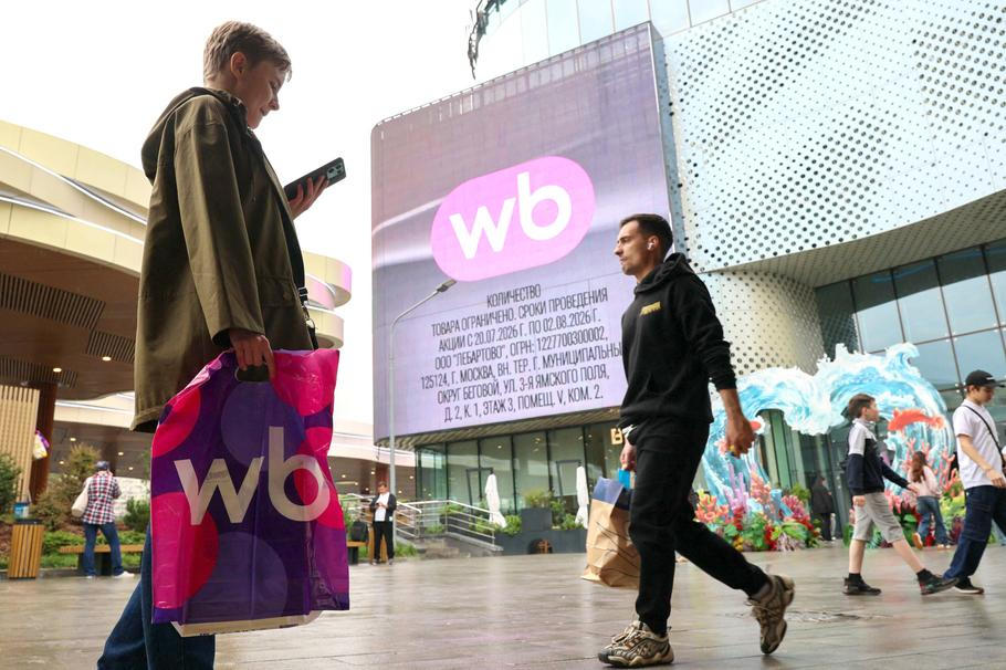 People walk past an electronic screen advertising Wildberries online retailer in Moscow