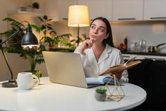 Young,Woman,At,Night,Home,Studies,On,Laptop,Watches,Lesson