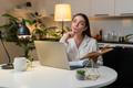 Young,Woman,At,Night,Home,Studies,On,Laptop,Watches,Lesson