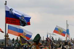 Flags fly over the graves of Russian service members in Donetsk