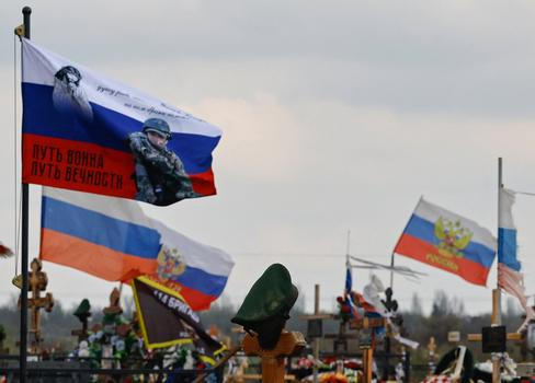 Flags fly over the graves of Russian service members in Donetsk