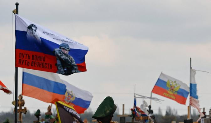 Flags fly over the graves of Russian service members in Donetsk