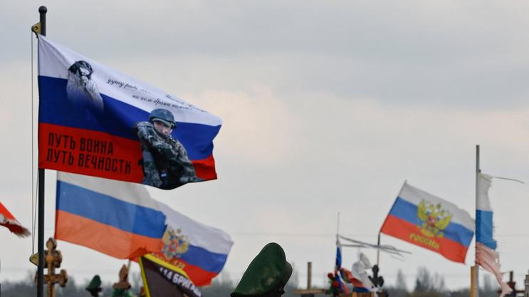 Flags fly over the graves of Russian service members in Donetsk