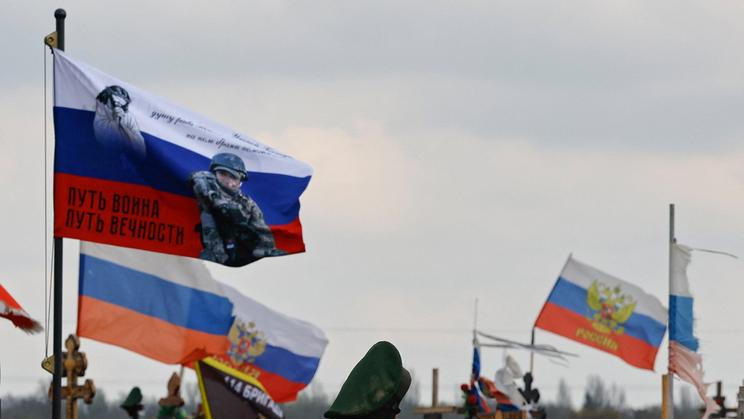 Flags fly over the graves of Russian service members in Donetsk