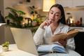 Young,Woman,At,Night,Home,Studies,On,Laptop,Watches,Tutorial