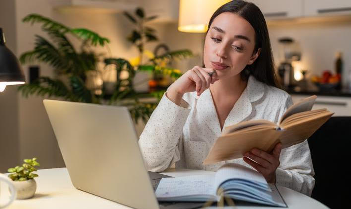 Young,Woman,At,Night,Home,Studies,On,Laptop,Watches,Tutorial