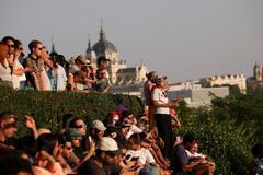 People observe a partial solar eclipse in Madrid
