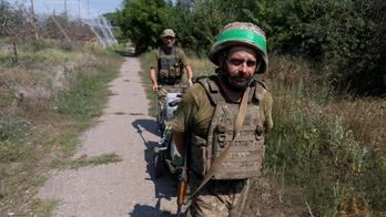 Ukrainian servicemen carry their staff along a street in the frontline town of Druzhkivka