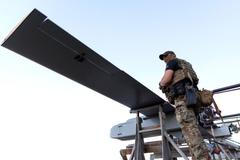 Ukrainian serviceman stands next to FP-1 deep-strike drones before their launch for a combat mission in an undisclosed location in Ukraine