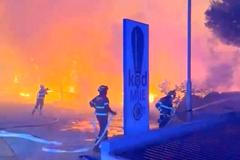 Firefighters work to extinguish a wildfire in Omis