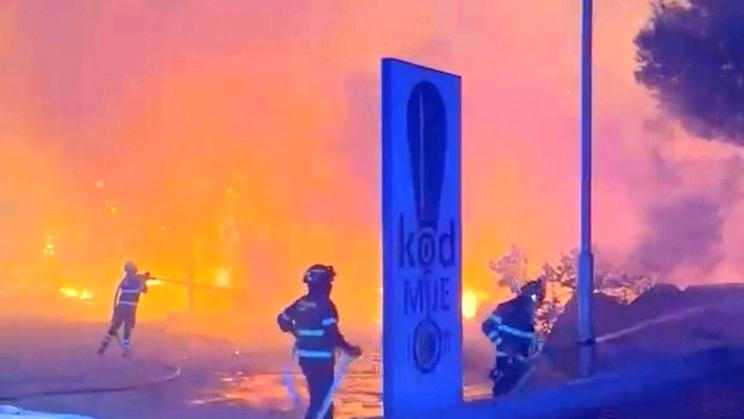 Firefighters work to extinguish a wildfire in Omis
