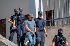 Police escort Vladimir Z. after a court hearing in Pula