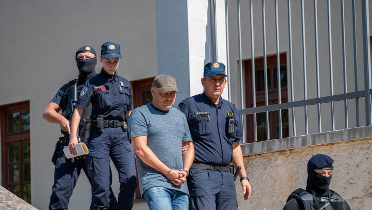 Police escort Vladimir Z. after a court hearing in Pula