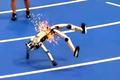 Humanoidní robot během tréninku na  „olympiádu humanoidních robotů“ skočil v jiskrách na zemi.