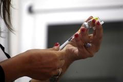FILE PHOTO: A health agent prepares a vaccine during a campaign of vaccination against yellow fever, dengue, chikungunya and zika in Buenos Aires