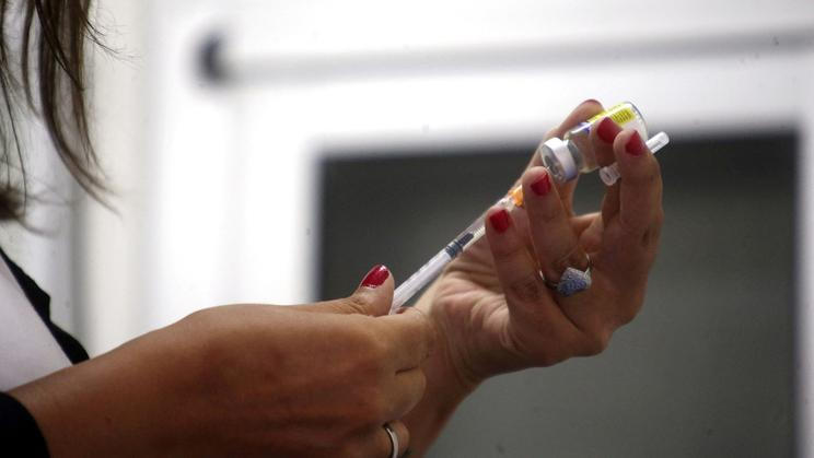 FILE PHOTO: A health agent prepares a vaccine during a campaign of vaccination against yellow fever, dengue, chikungunya and zika in Buenos Aires
