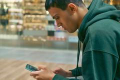 Young,Teenager,Sit,On,The,Bench,At,The,Mall,Holding