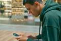 Young,Teenager,Sit,On,The,Bench,At,The,Mall,Holding
