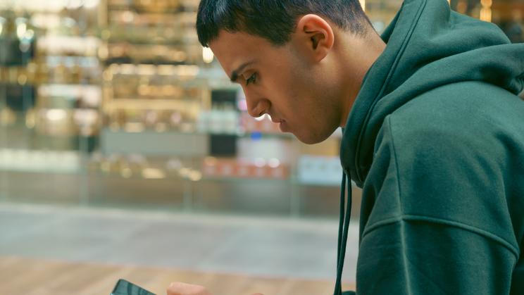 Young,Teenager,Sit,On,The,Bench,At,The,Mall,Holding