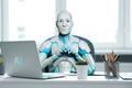 A,Futuristic,Humanoid,Ai,Robot,Sitting,At,A,Modern,Office