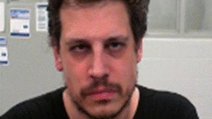 Milo Yiannopoulos poses after his arrest by federal immigration agents at the Louis Armstrong New Orleans International Airport