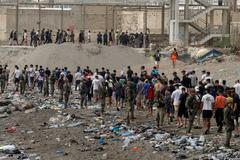 FILE PHOTO: Migrants cross into the Spanish enclave of Ceuta