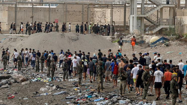 FILE PHOTO: Migrants cross into the Spanish enclave of Ceuta