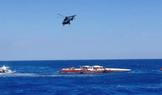 A helicopter flies during a rescue operation after a ferry that capsized off the coast of Northern Cyprus
